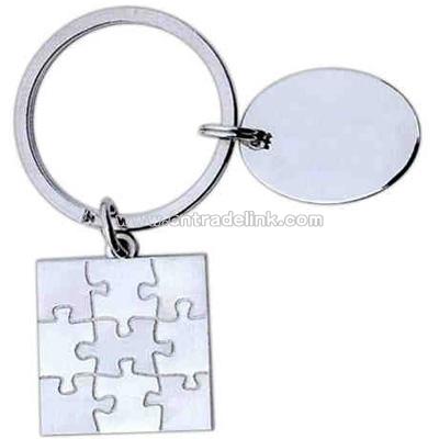 Nickel finished puzzle shape designer key tag with 1" oval dangler.
