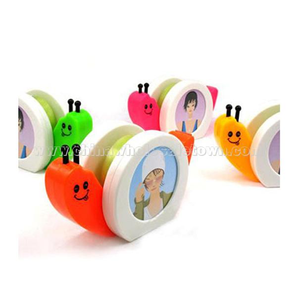 Snail tape dispenser with photo frame